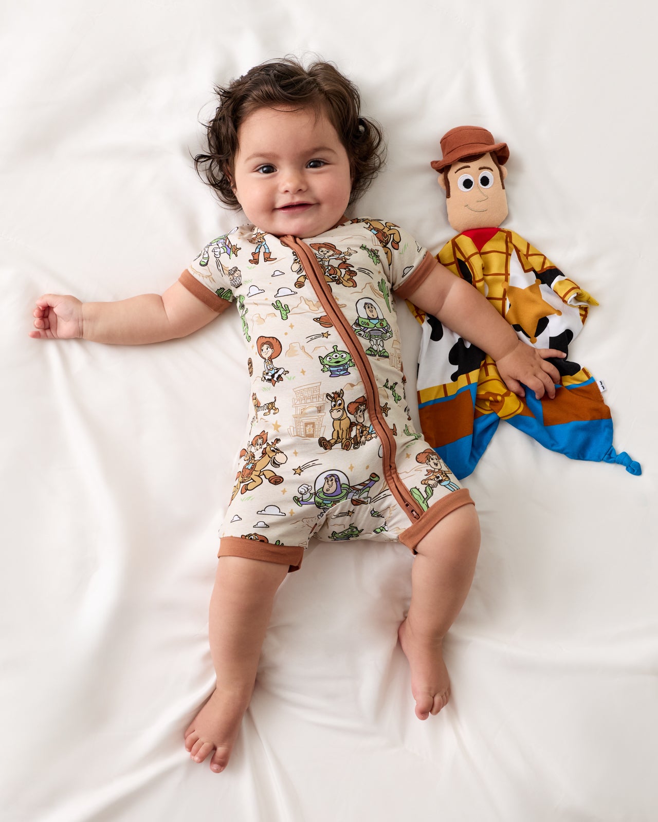 Baby laying with the Pixar Toy Story Woody Lovey 