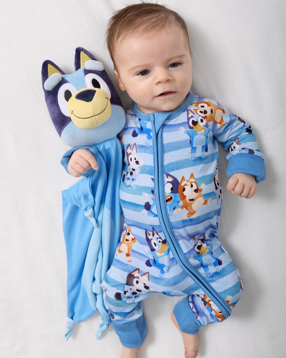 Baby laying next to the Bluey Lovey in the Bluey Dance All Day Zippy