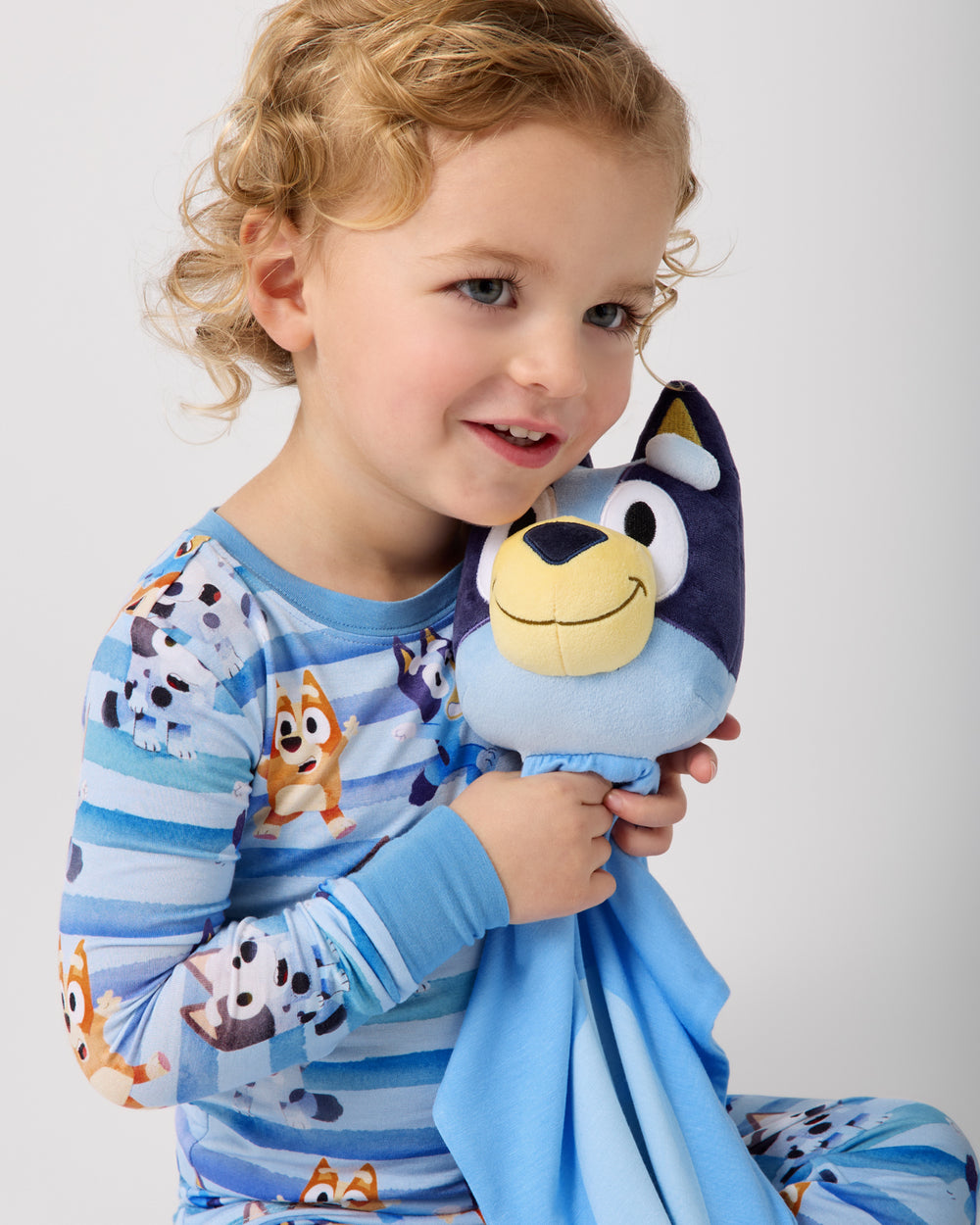 Child holding the Bluey Lovey