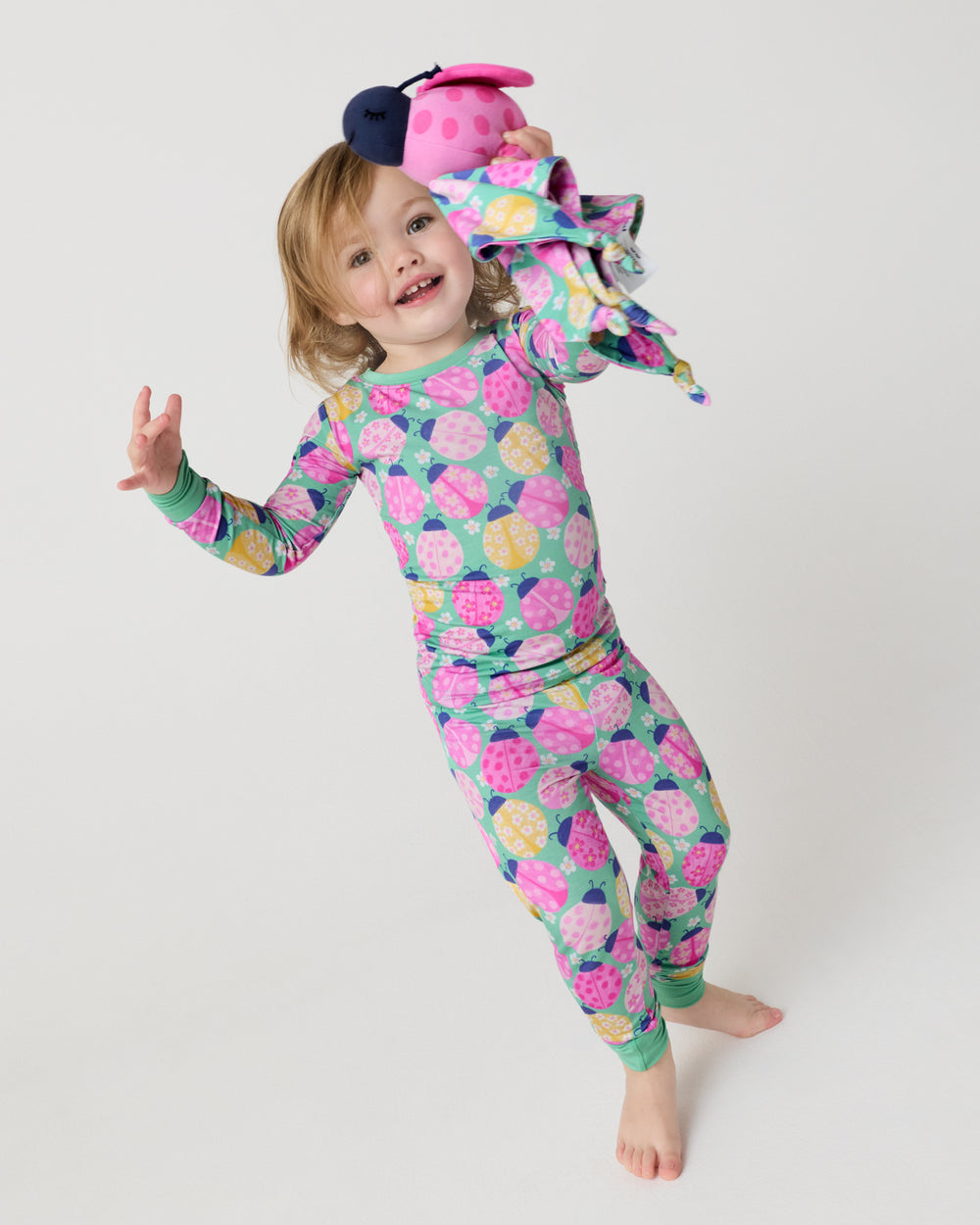 Child in motion holding the Rosie the Ladybug Sleepyhead Lovey 