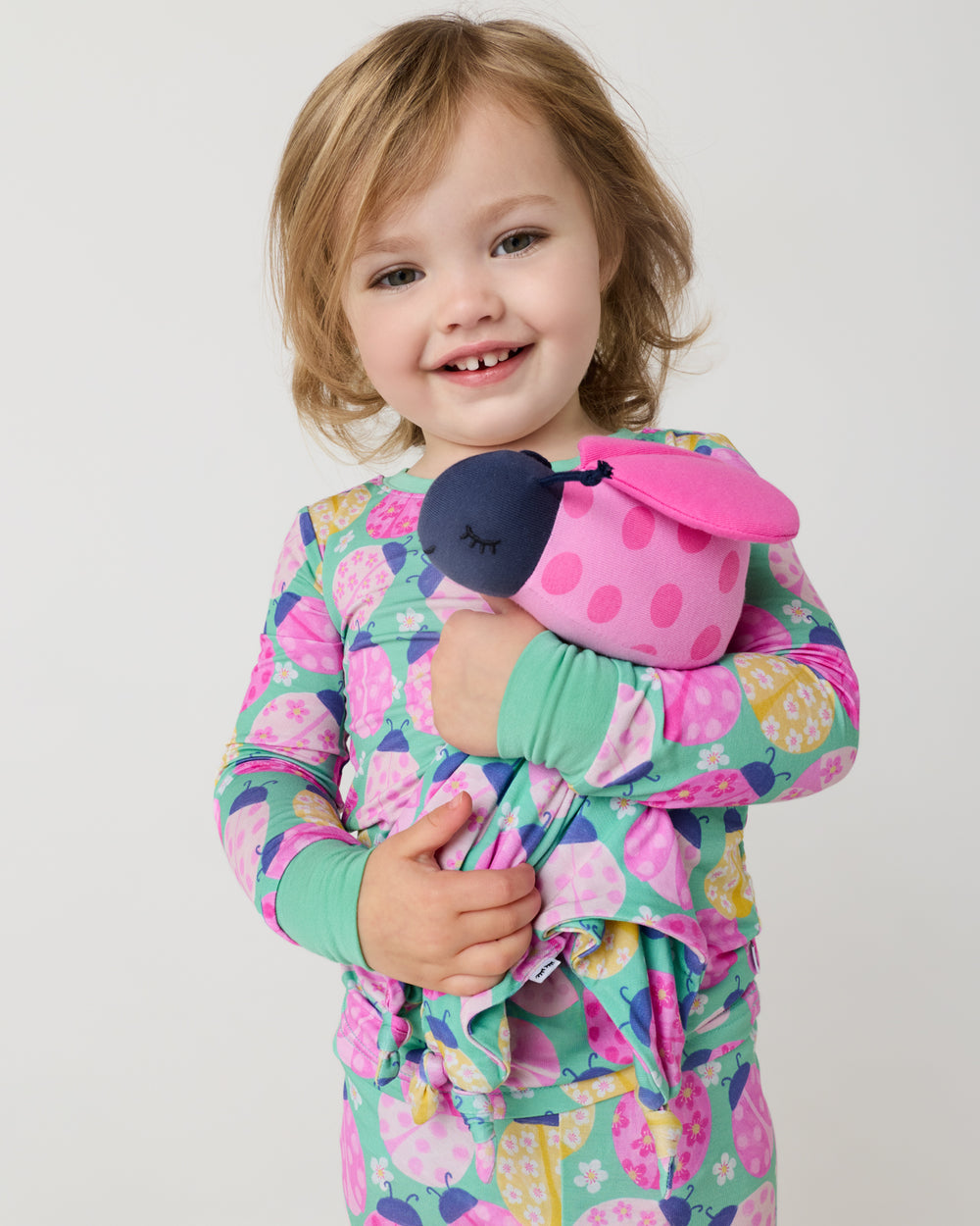 Alternate child holding the Rosie the Ladybug Sleepyhead Lovey