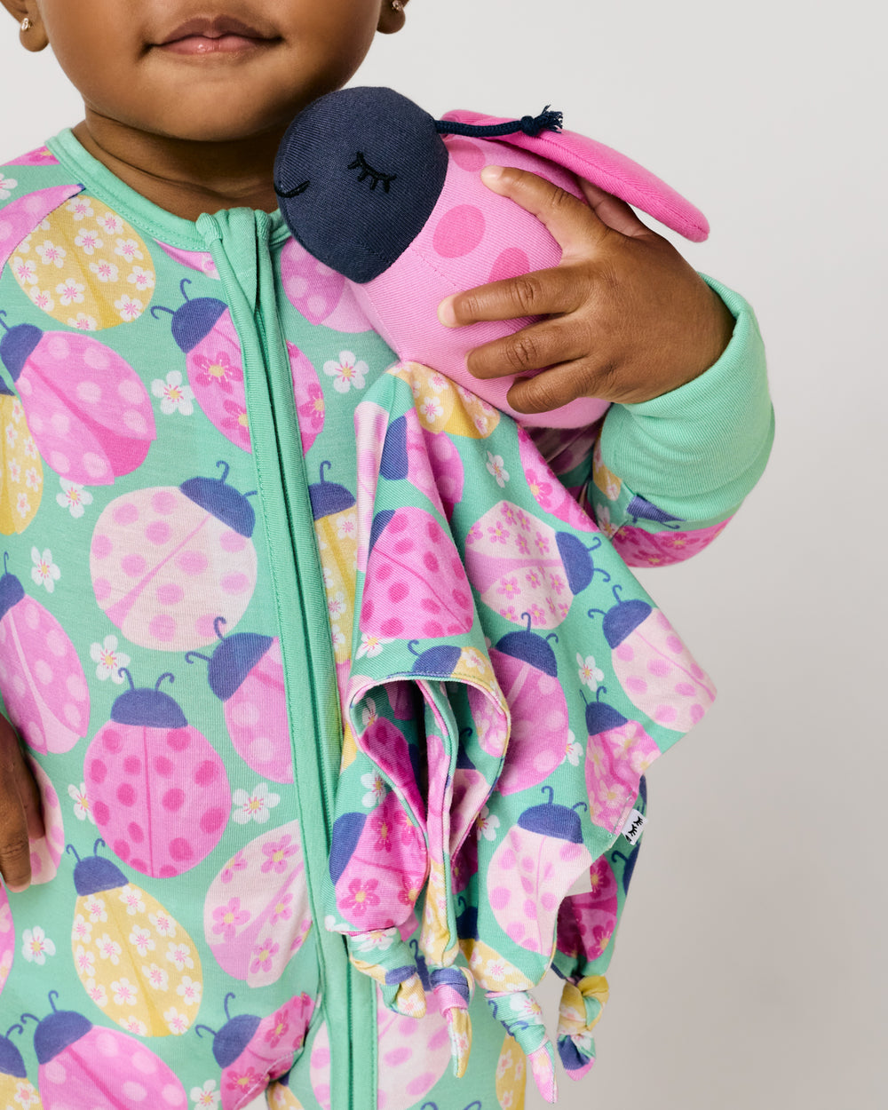 Baby holding the Rosie the Ladybug Sleepyhead Lovey
