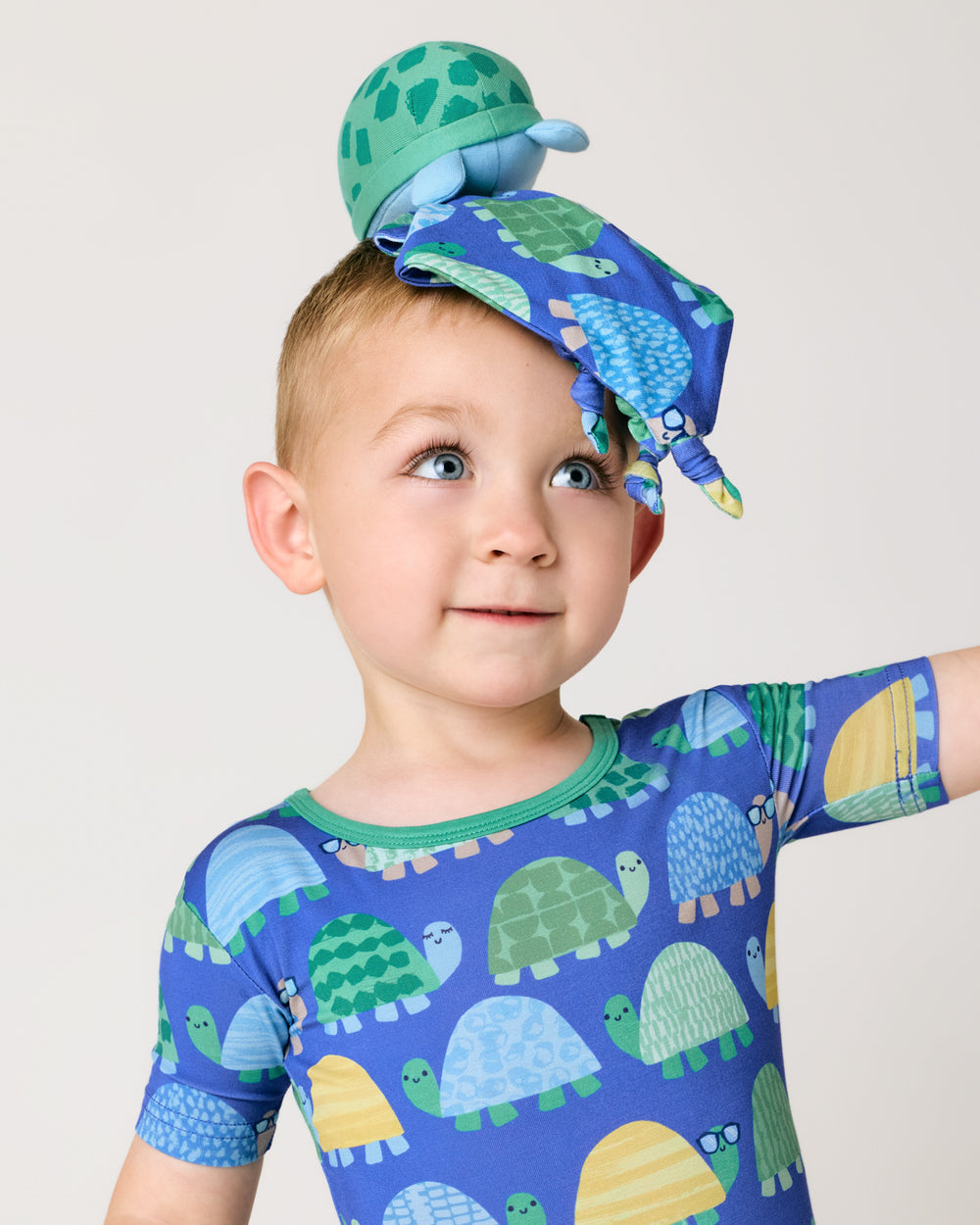 Boy with the Ty the Turtle Sleepyhead Lovey resting on his head