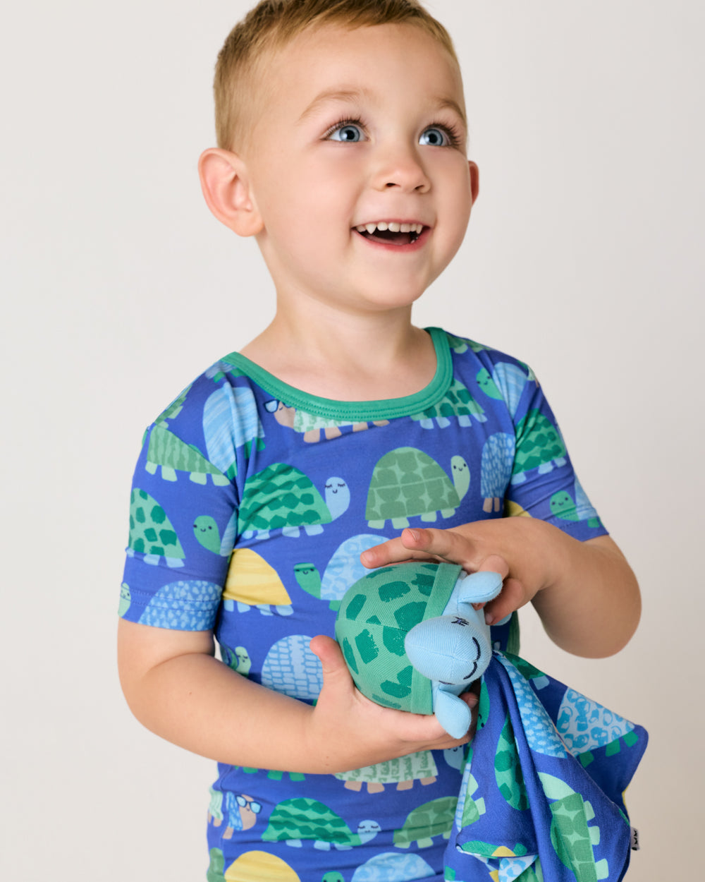 Child holding the Ty the Turtle Sleepyhead Lovey