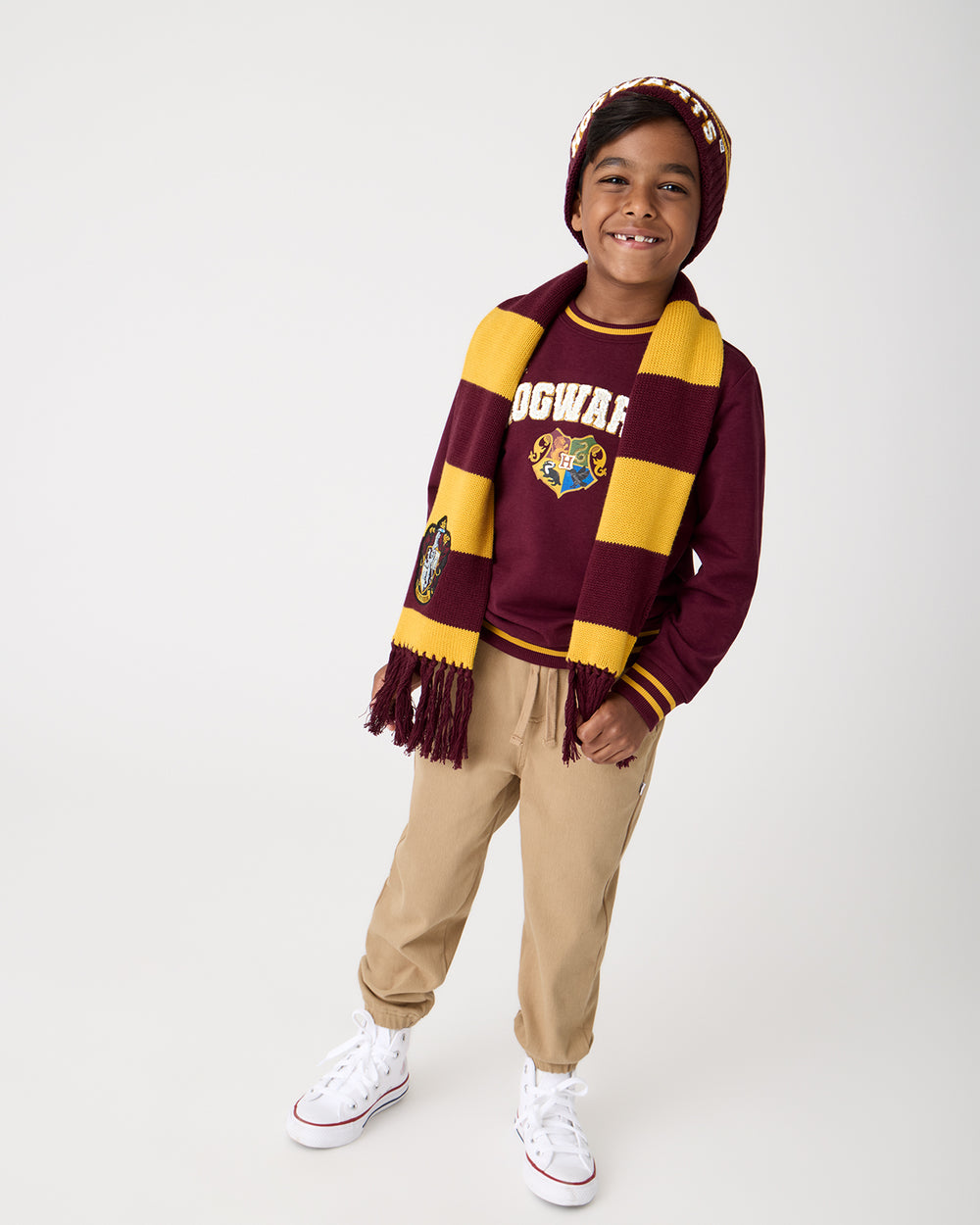 Boy wearing the Harry Potter™  Gryffindor Scarf with a Hogwarts sweatshirt
