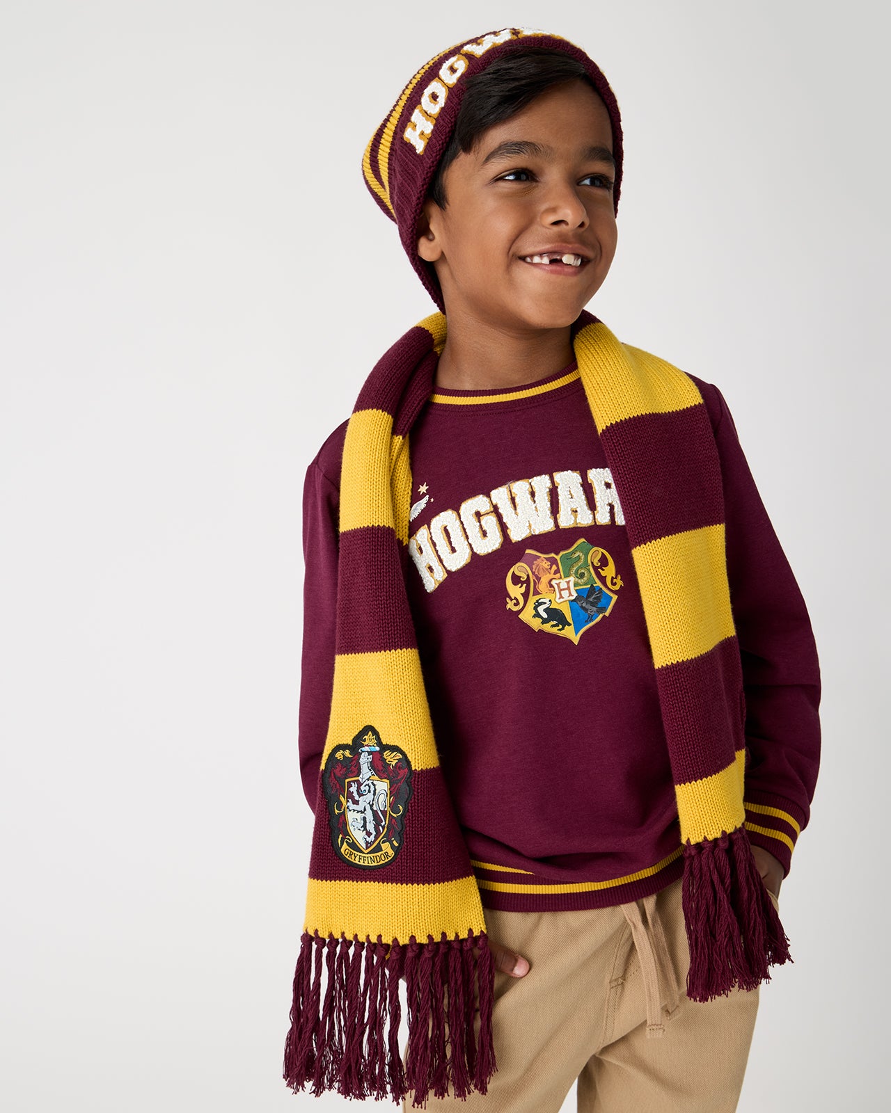 Boy wearing the Harry Potter™  Gryffindor Scarf