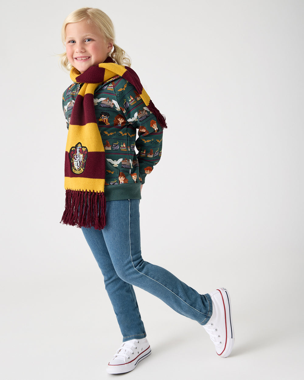 Girl wearing the Harry Potter™  Gryffindor Scarf over a zip hoodie