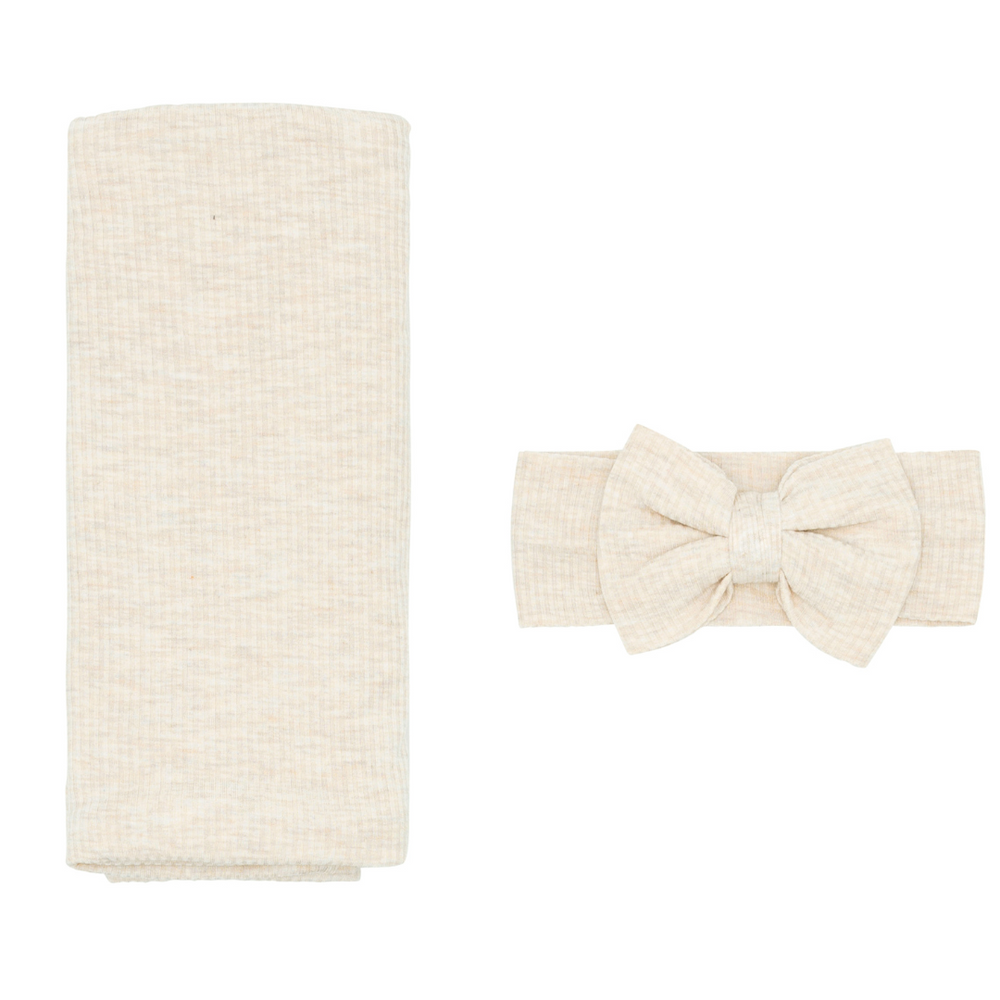 Flat lay image of a Heather Oatmeal Ribbed Swaddle and Luxe Bow Headband Set