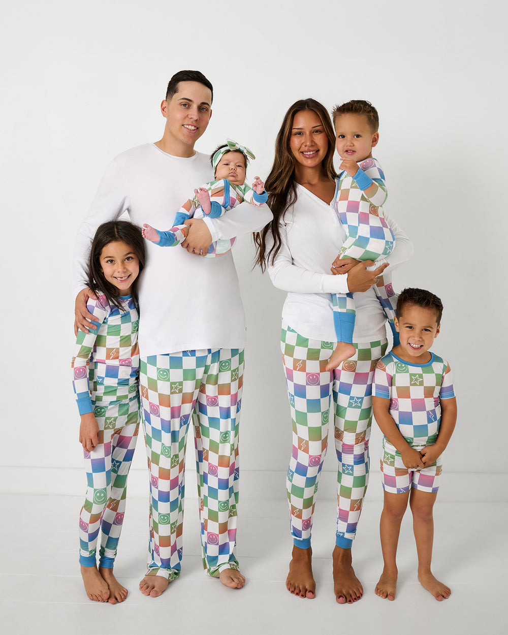 Family of six wearing matching Ombre Cheery Checks bamboo checkerboard pajamas