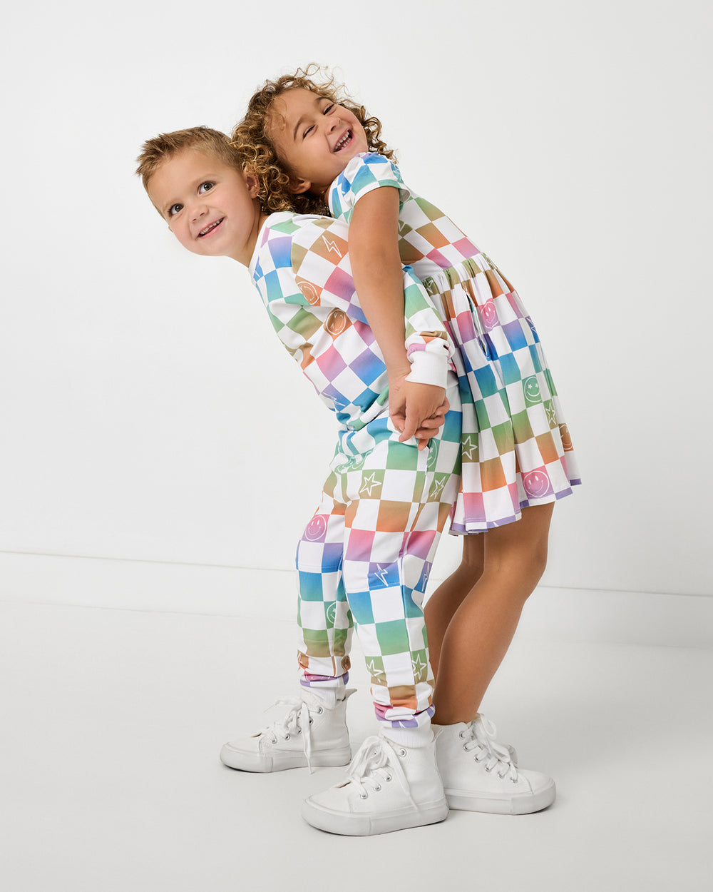 Two children wearing matching Ombre Cheery Checks play styles