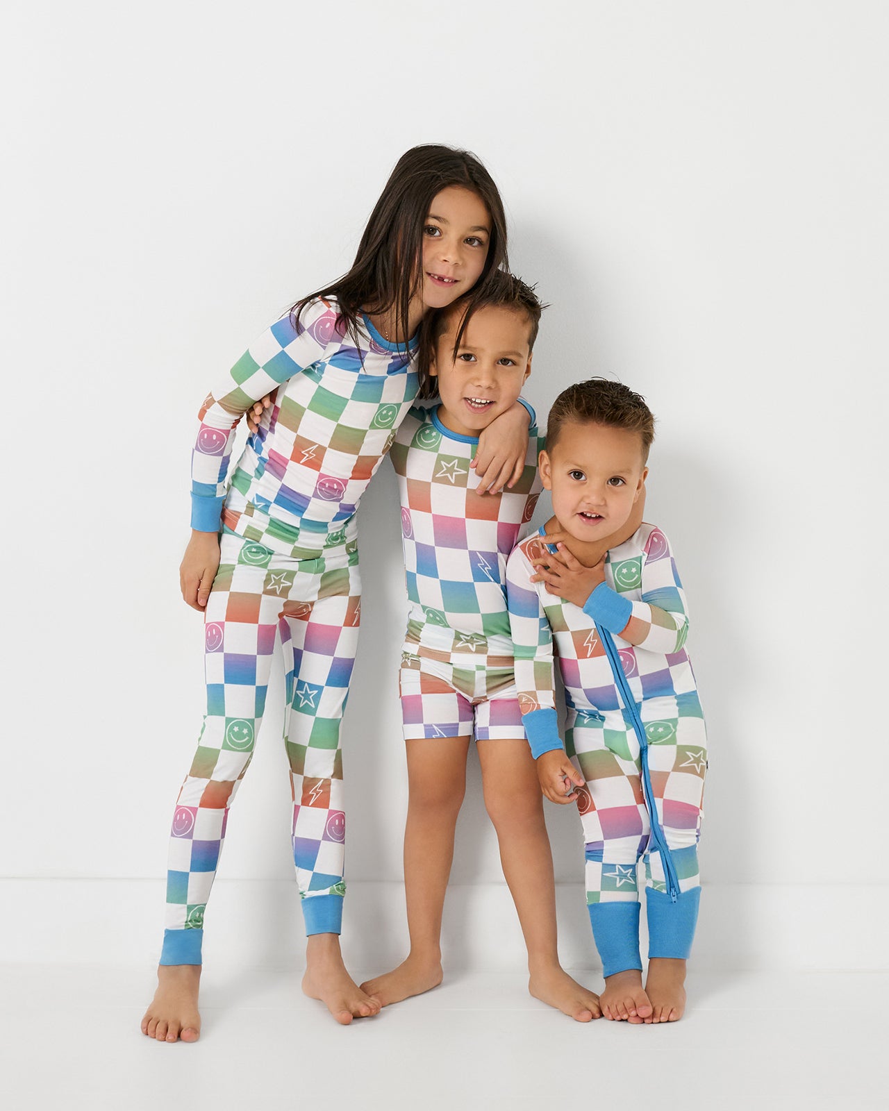 Group of three kids wearing matchin g Ombre Cheery Checks bamboo pajamas