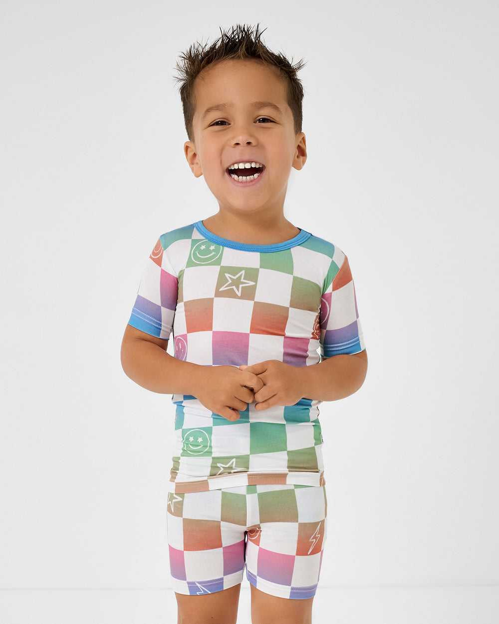 Close up of boy wearing the Ombre Cheery Checks Two-Piece Short Sleeve & Shorts Pajama Set