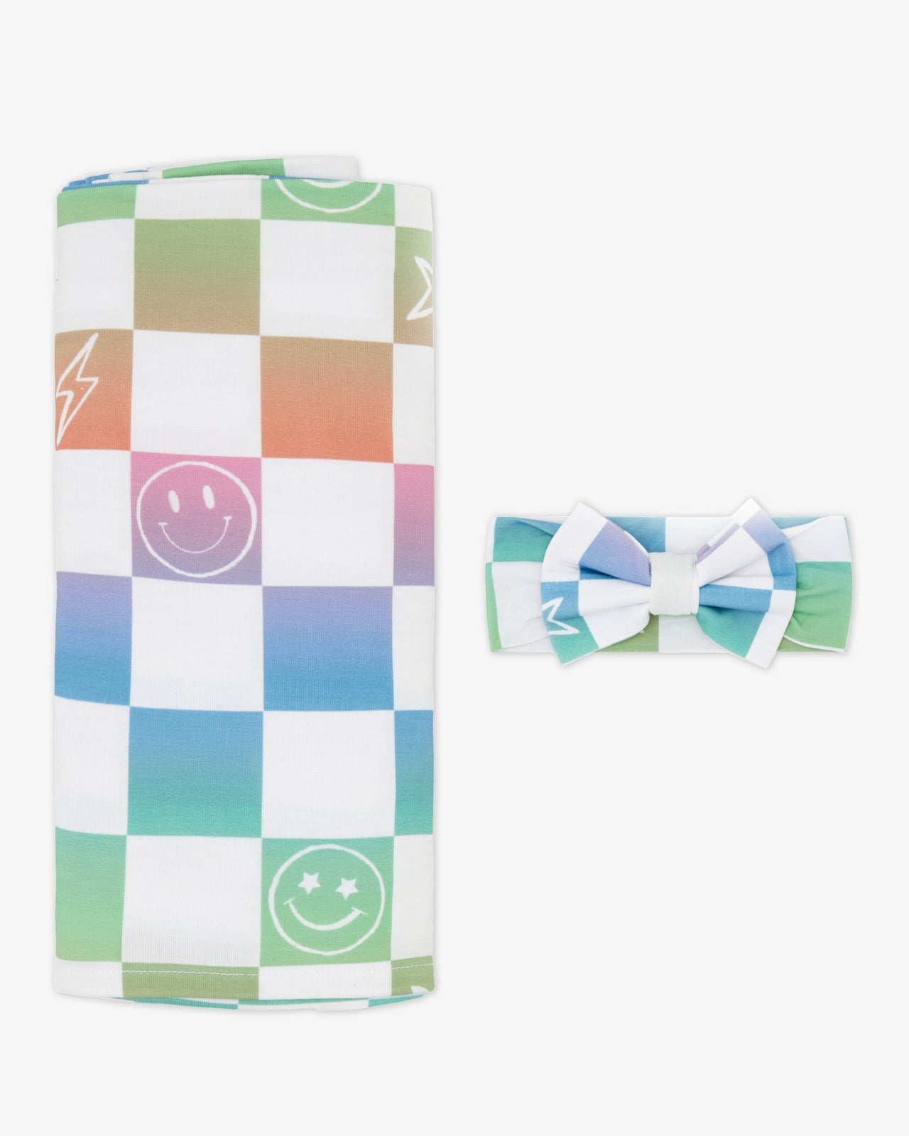 Flat lay of the Ombre Cheery Checks Swaddle & Luxe Bow Headband Set
