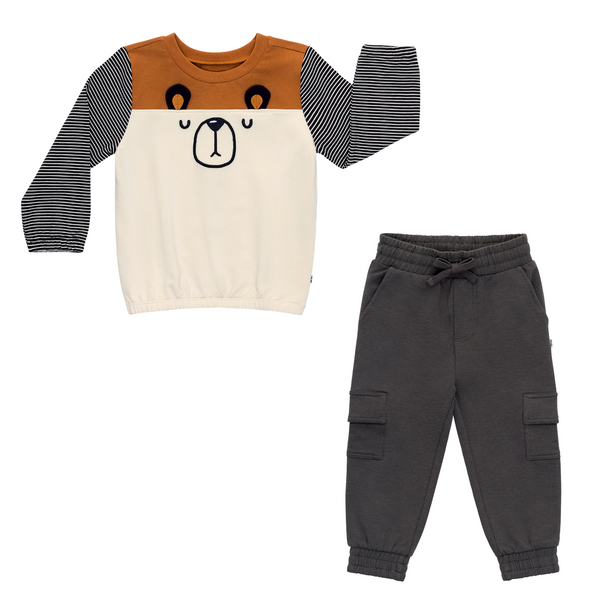 flat lay composite of an arctic cinched panel crewneck and washed black cargo jogger