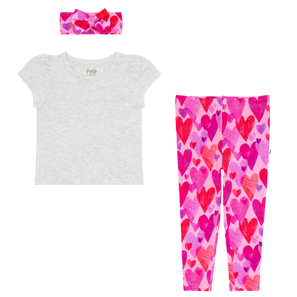 flat lay composite of a light heather gray puff sleeve tee and pink hearts & crafts legging and luxe bow headband