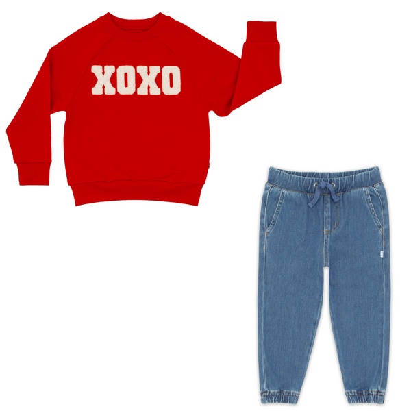 flat lay composite of an xoxo crewneck sweatshirt and midwash blue denim jogger