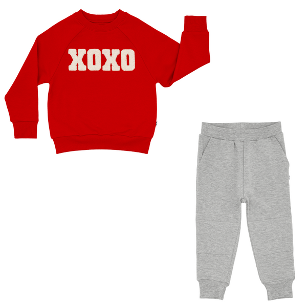 Flat lay composite of an xoxo crewneck sweatshirt and heather gray jogger