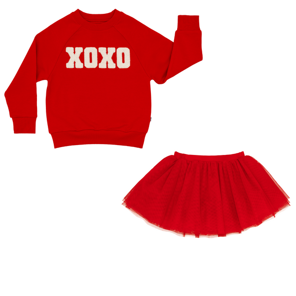 flat lay composite of an xoxo crewneck sweatshirt and candy red tutu skirt