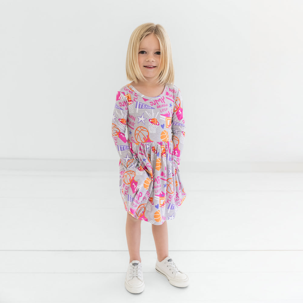 Child standing wearing the Pink Slam Dunk Skater Dress