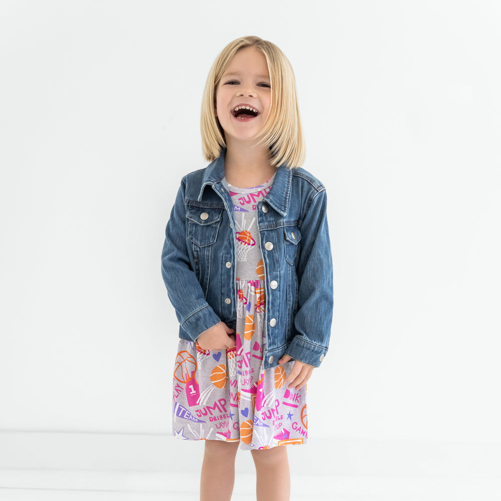 Child wearing the Pink Slam Dunk Skater Dress with a denim trucker jacket