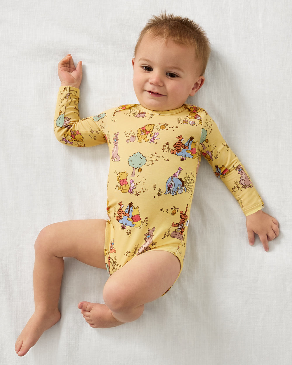 Aerial view of baby wearing the Disney Playtime With Pooh Bodysuit