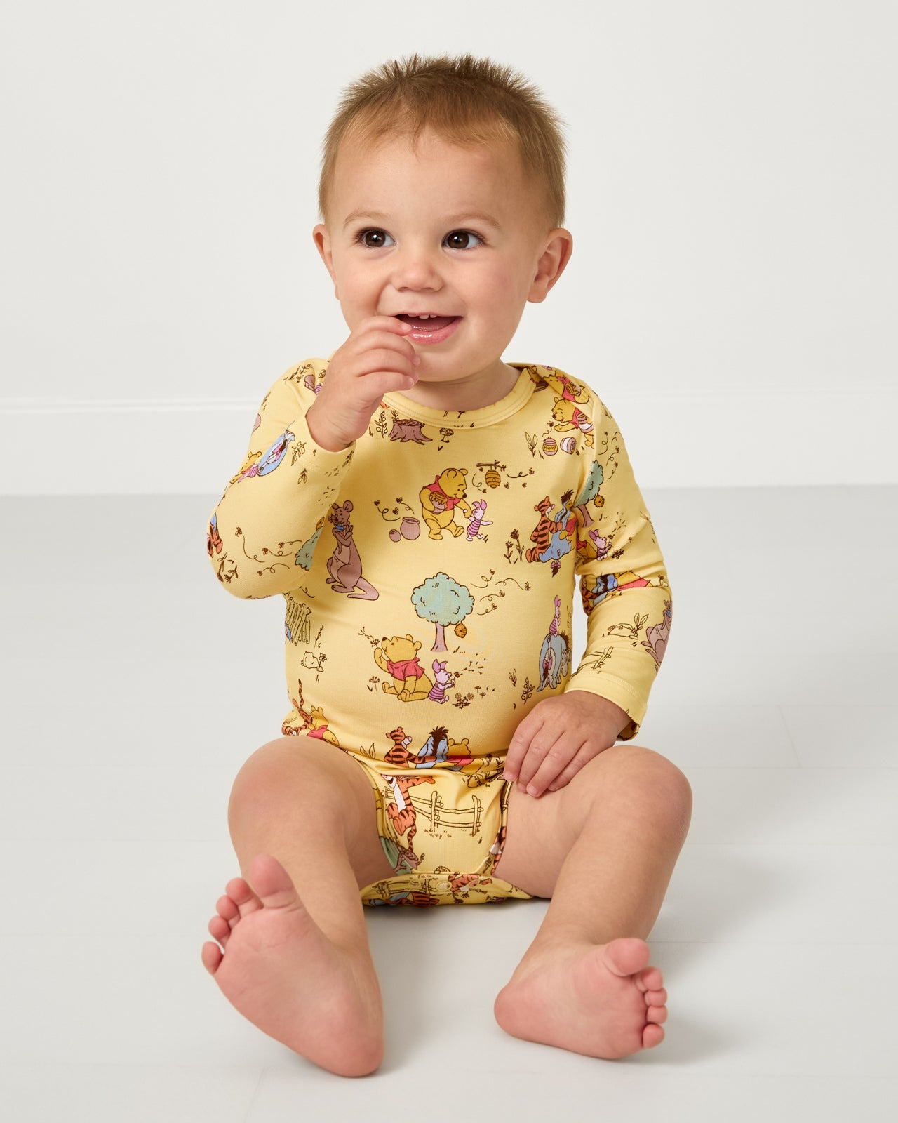 Sitting baby wearing the Disney Playtime With Pooh Bodysuit