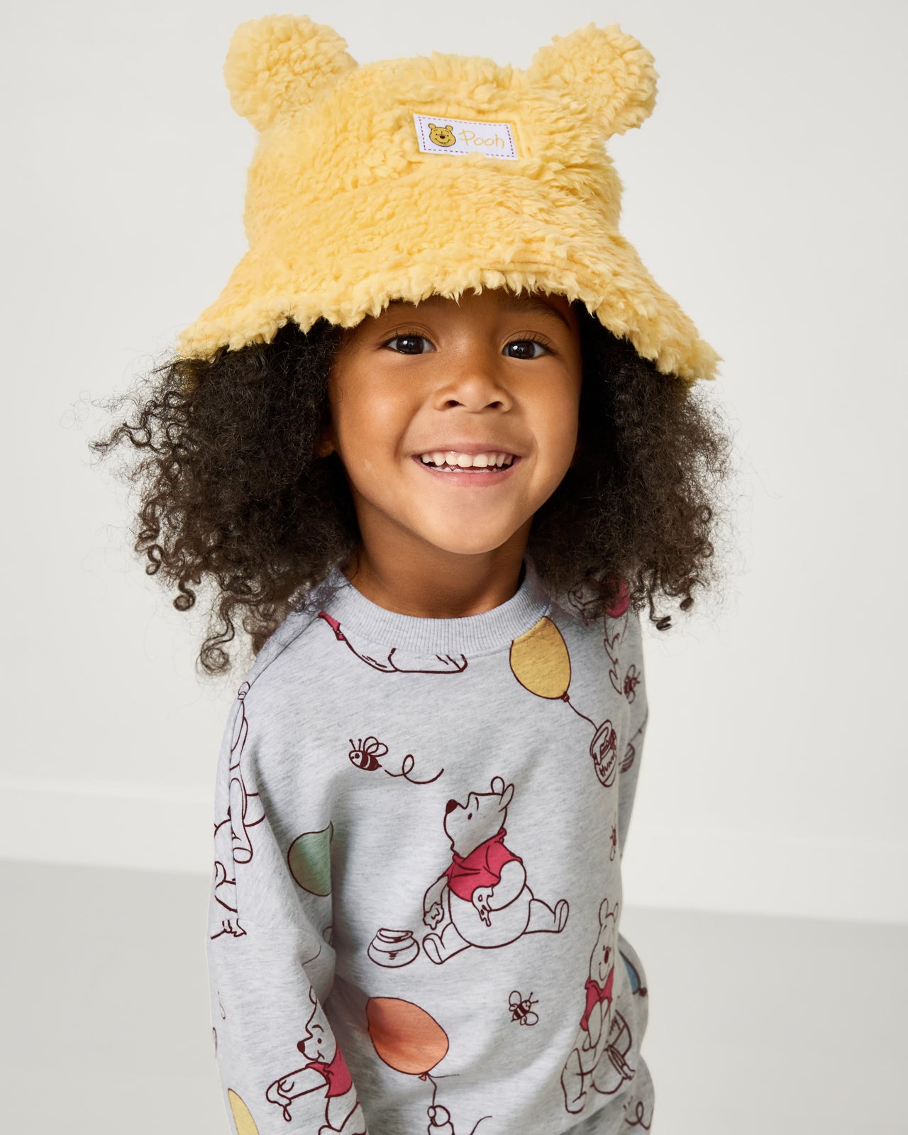 Girl wearing the Disney Winnie the Pooh Sherpa Bucket Hat