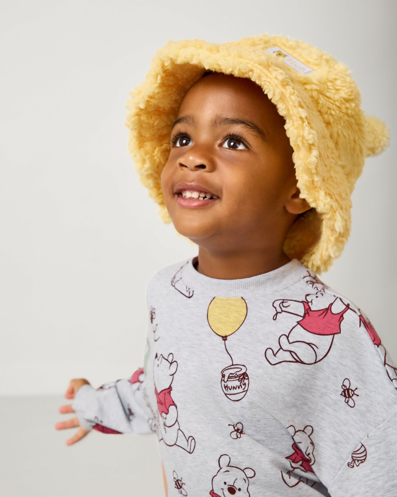 Boy wearing the Disney Winnie the Pooh Sherpa Bucket Hat