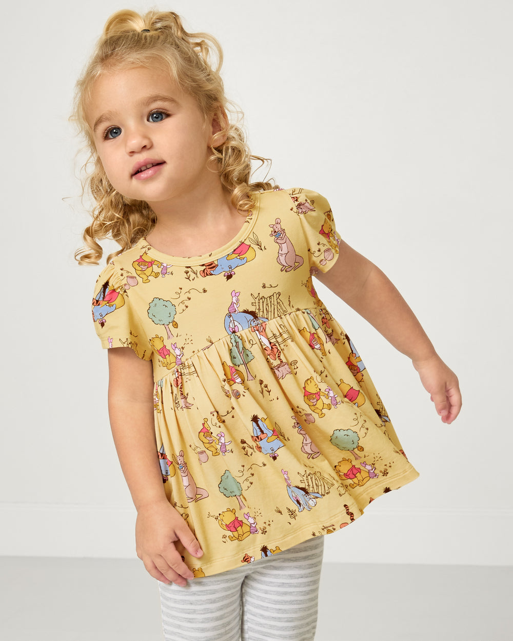 Girl wearing the Disney Playtime With Pooh Empire Tunic Top