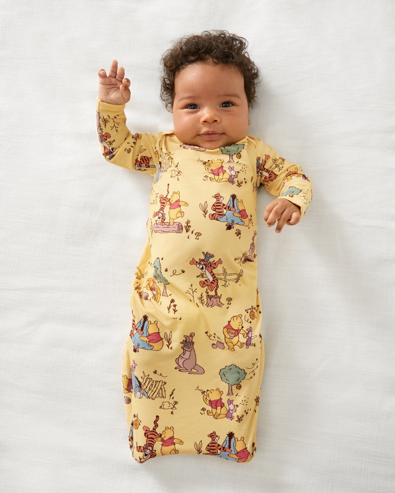 Aerial view of baby wearing the Disney Playtime With Pooh Infant Gown