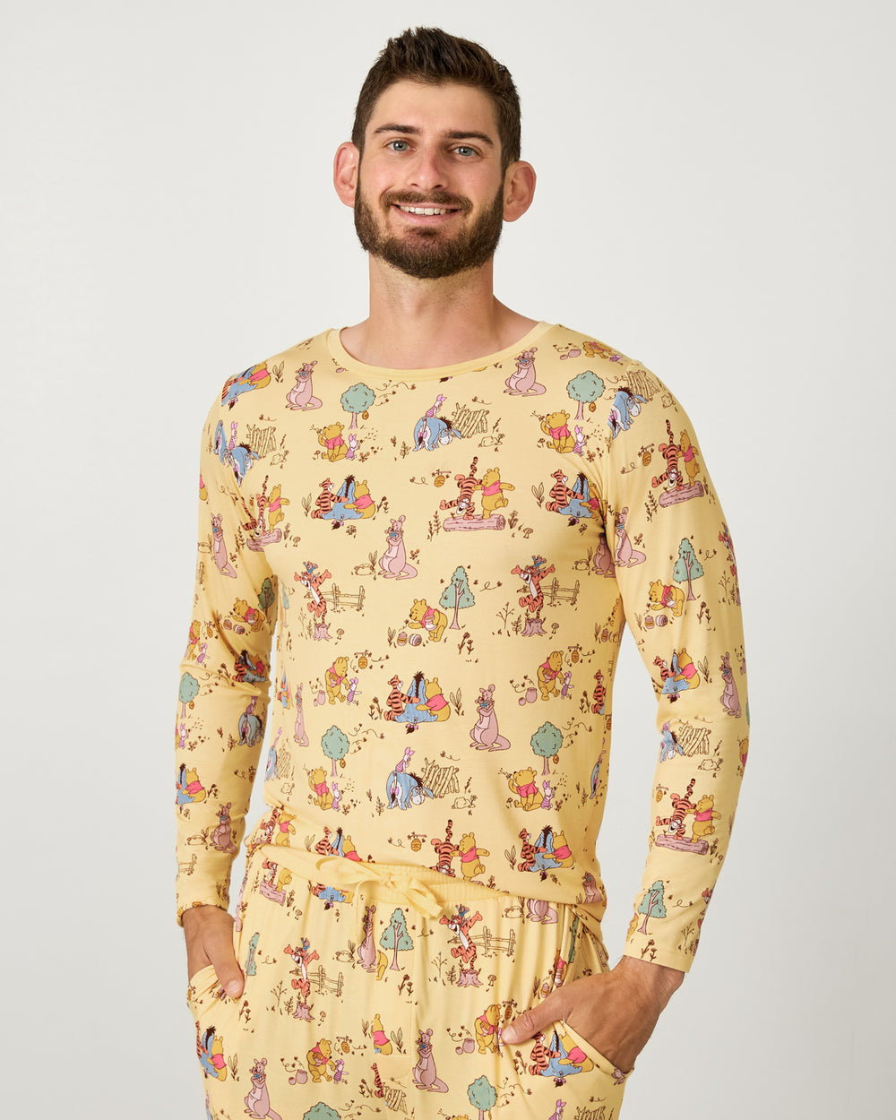 Man wearing the Disney Playtime With Pooh Men's Long Sleeve Pajama Top