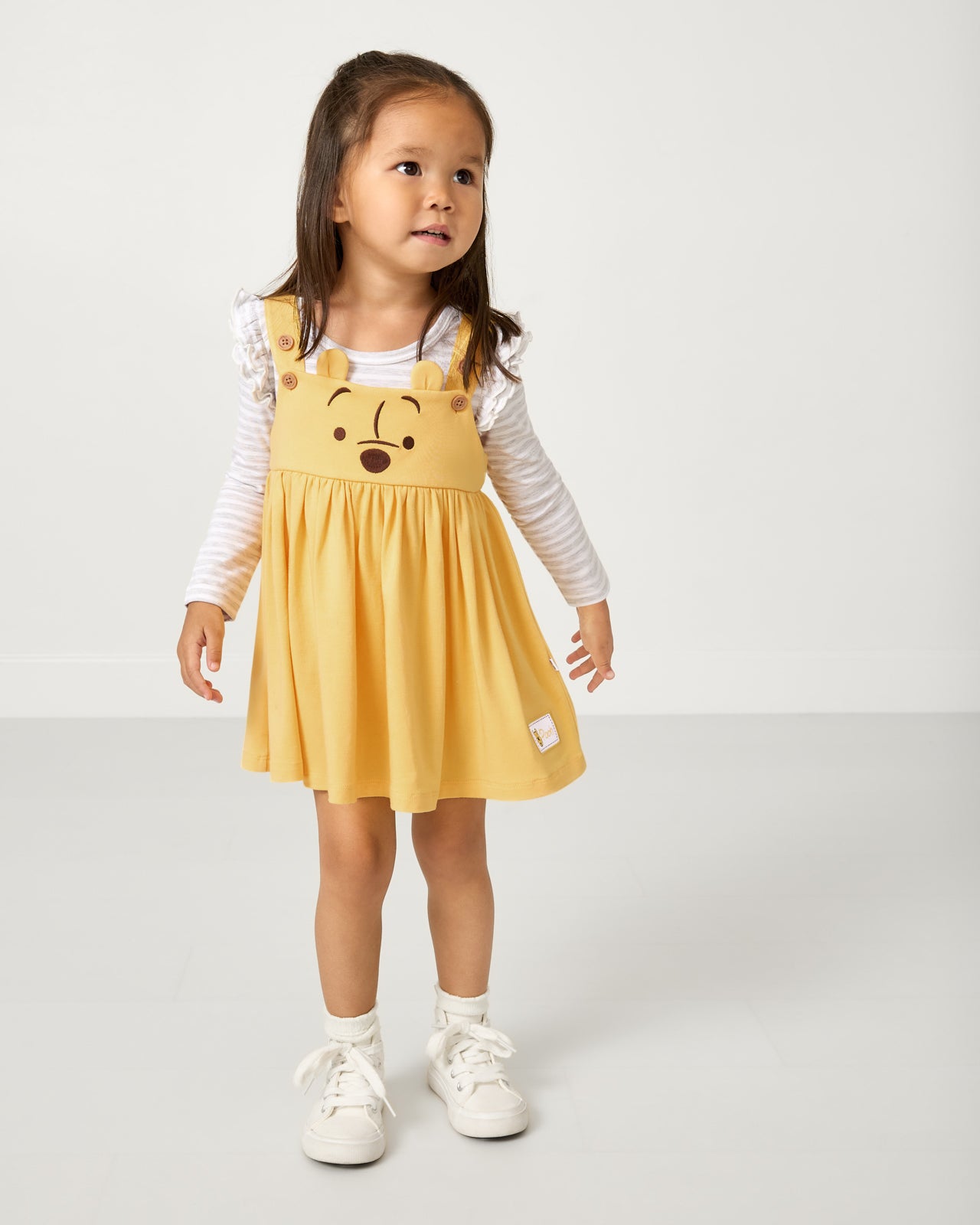 Girl wearing the Disney Winnie The Pooh Overall Dress