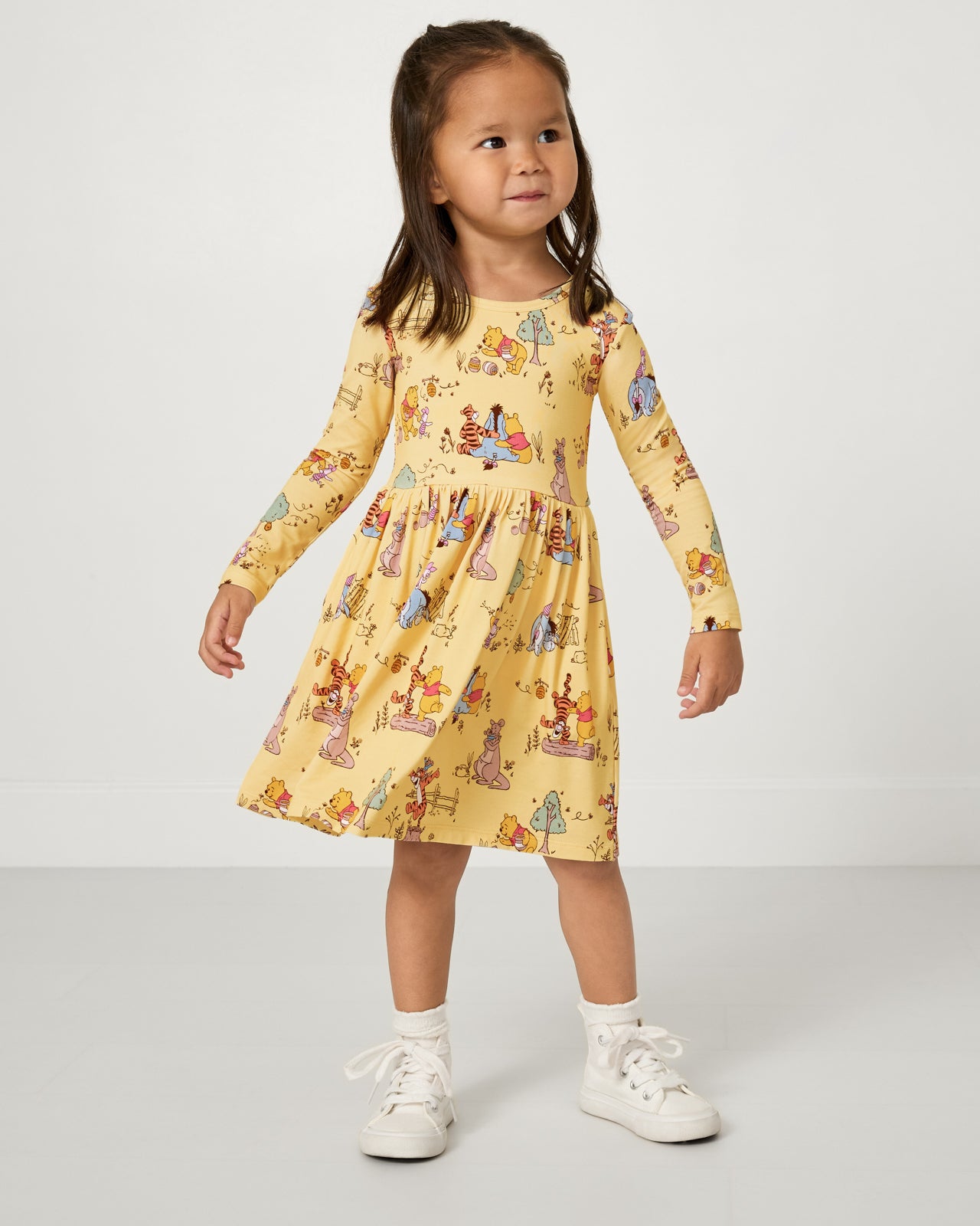Standing girl wearing the Disney Playtime With Pooh Skater Dress