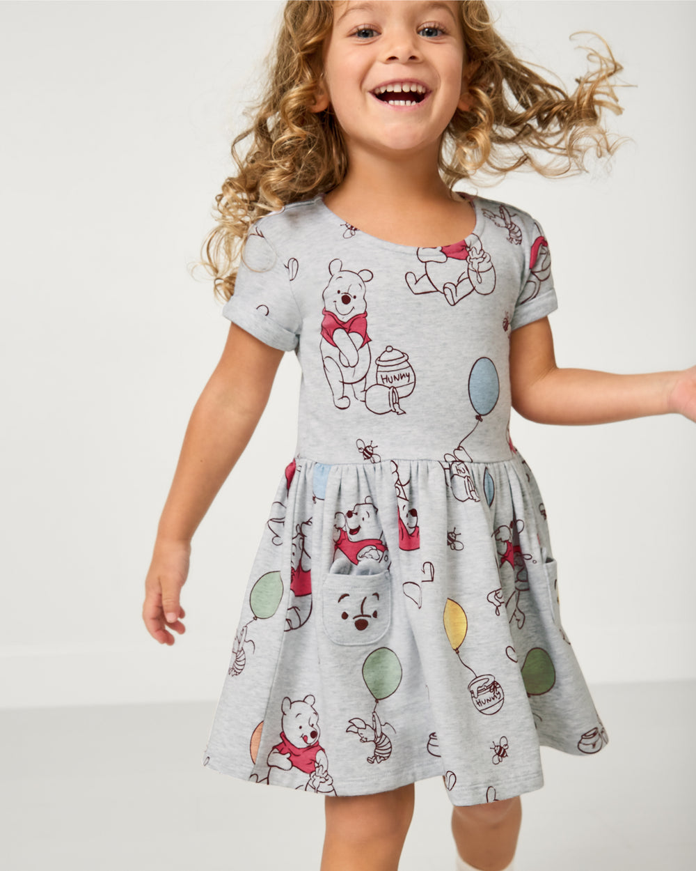 Girl wearing the Disney Up, Up and Away Patch Pocket Dress