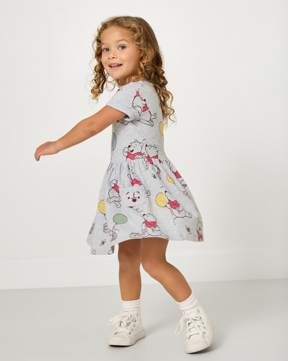 Twirling girl wearing the Disney Up, Up and Away Patch Pocket Dress