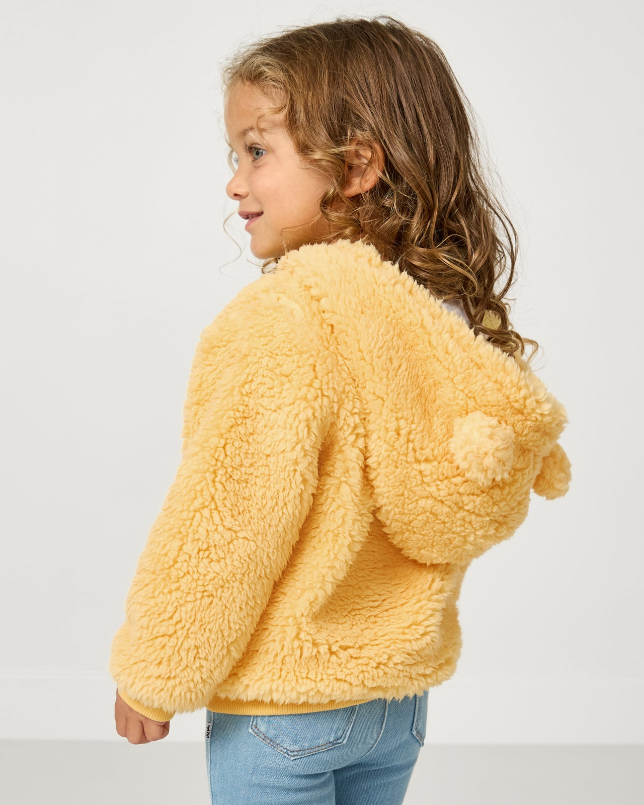 Back view of girl wearing the Disney Winnie the Pooh Sherpa Zip Hoodie