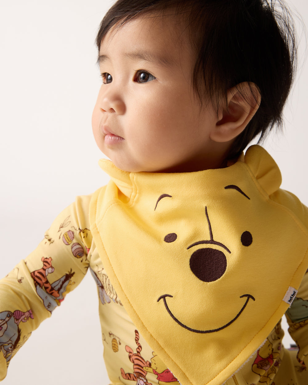 Close up of baby wearing the Disney Winnie The Pooh Bandana Bib
