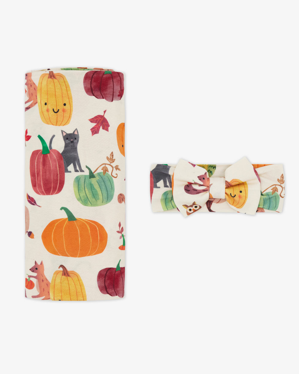 Flat lay of the Pumpkin Pals Swaddle & Luxe Bow Headband Set