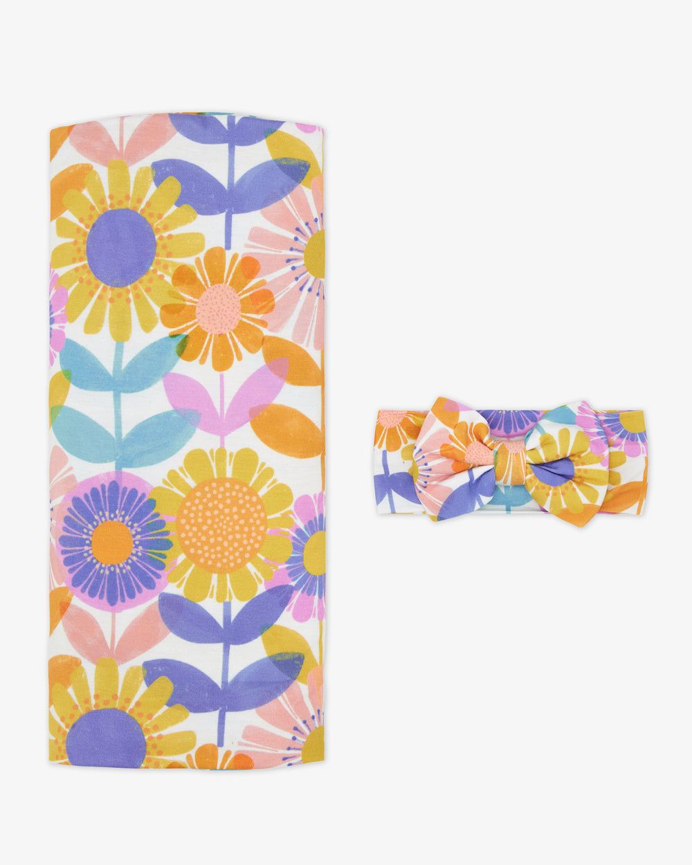 Flat lay of the Petal Power Swaddle & Luxe Bow Headband Set