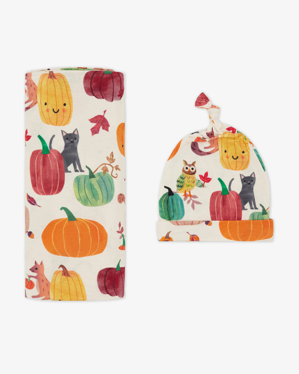 Flat lay of the Pumpkin Pals Swaddle & Hat Set