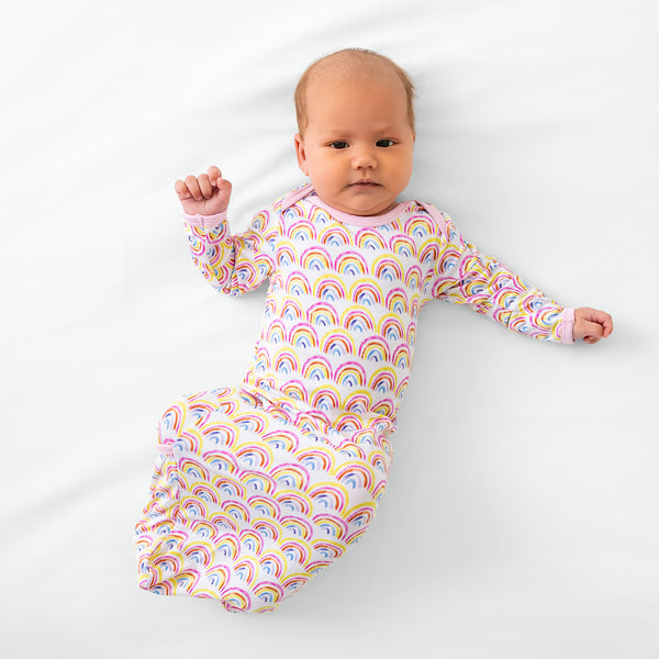 Aerial view of baby wearing the Pastel Rainbows Infant gown