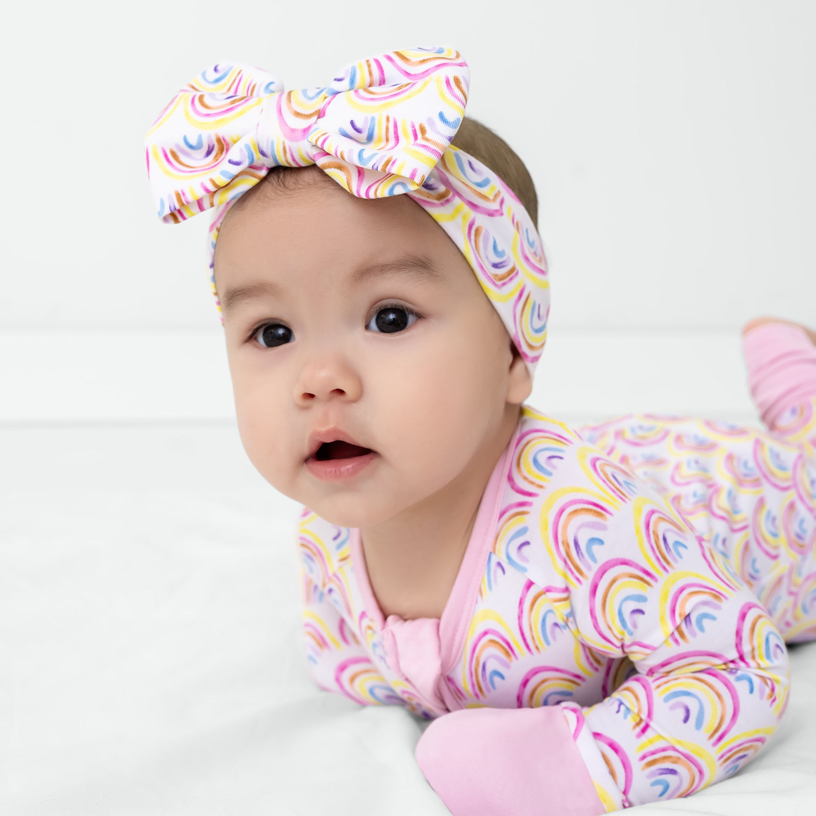 Crawling baby wearing the Pastel Rainbows Luxe Bow Headband