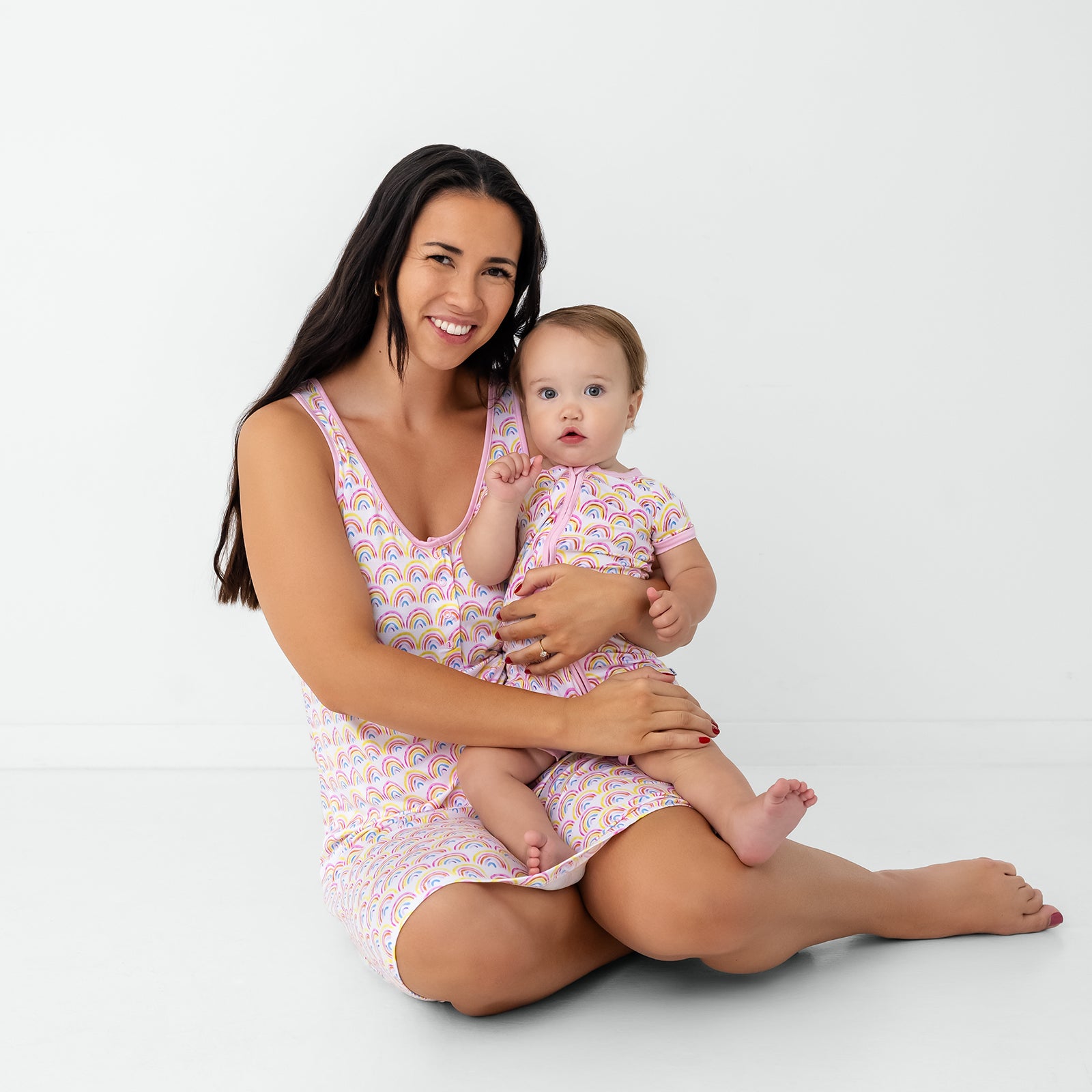 Mother and daughter wearing matching Pastel Rainbows bamboo pajamas