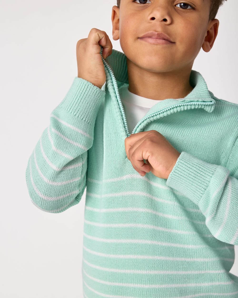 Close up of the zipper detail on the Pastel Green Stripe Zip Sweater