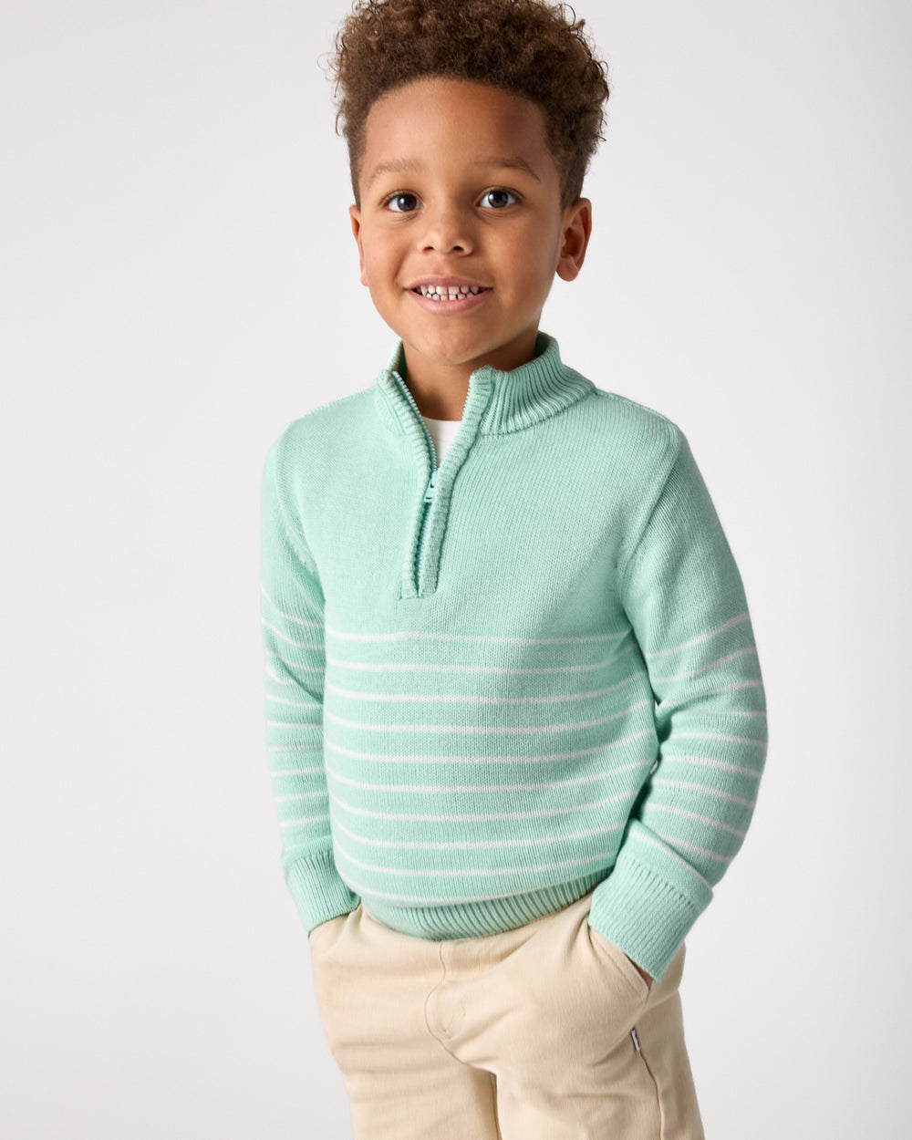 Boy wearing the Pastel Green Stripe Zip Sweater with chino shorts