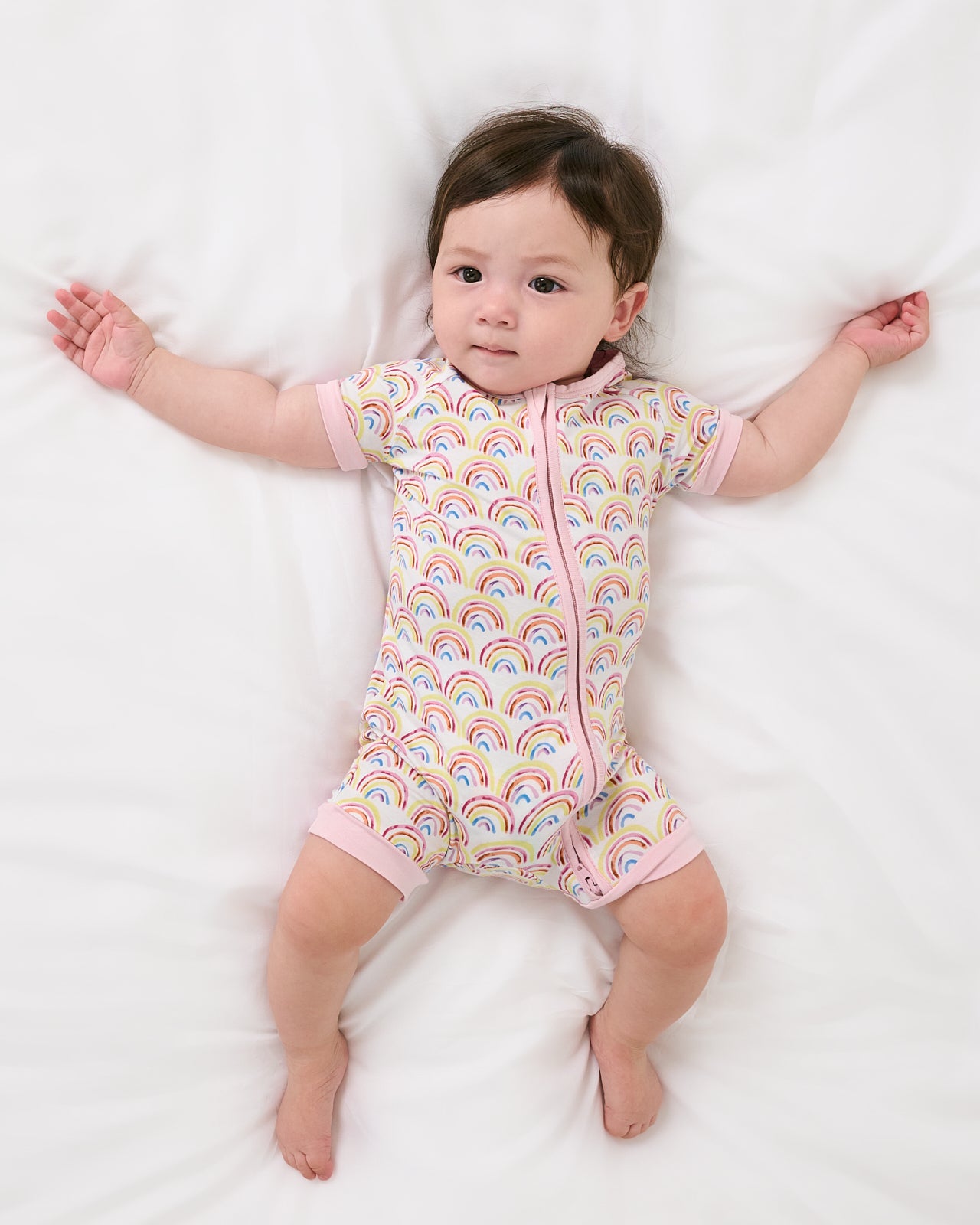 Aerial view of baby wearing the Pastel Rainbows Shorty Zippy