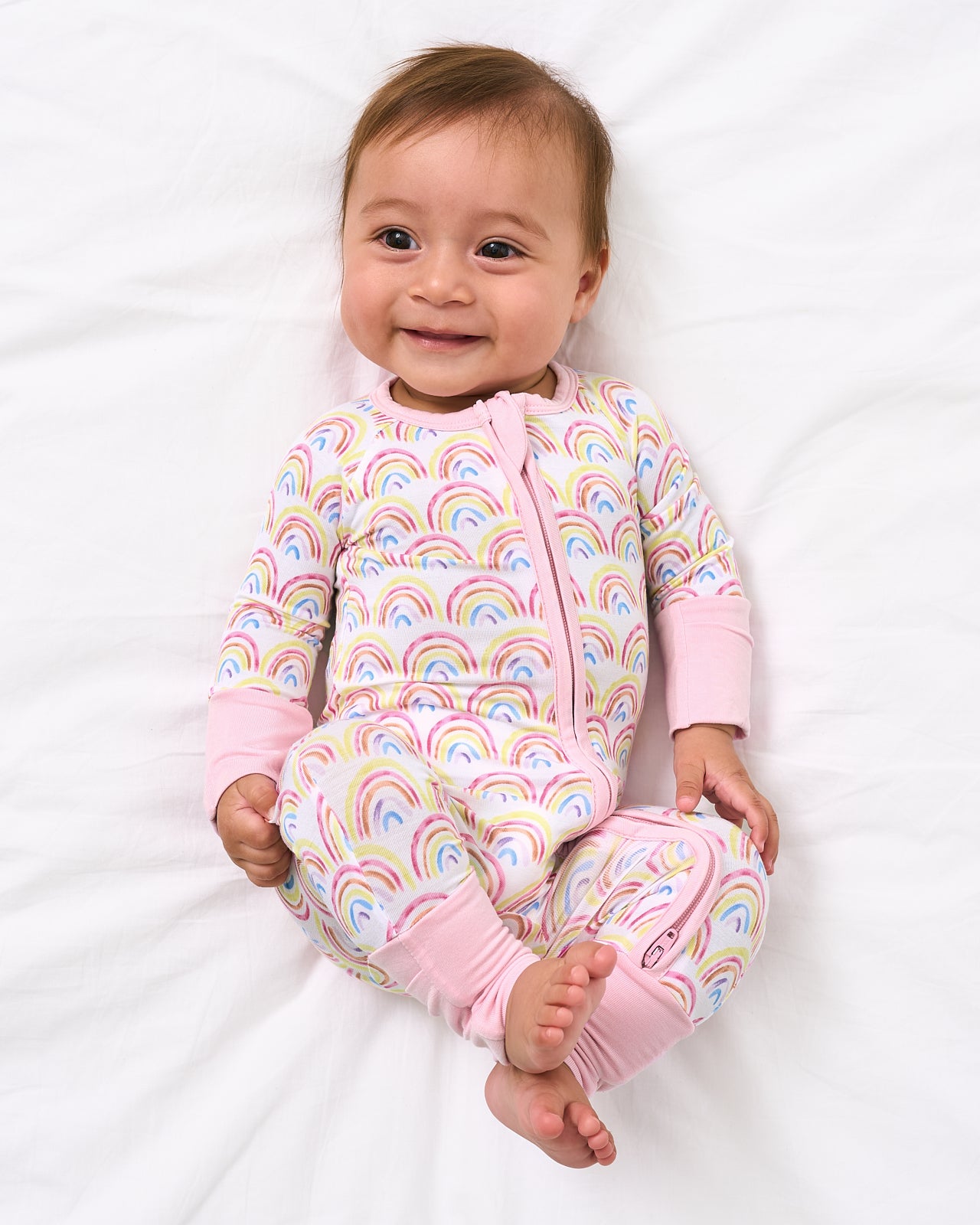 Aerial view of baby wearing the Pastel Rainbows Zippy
