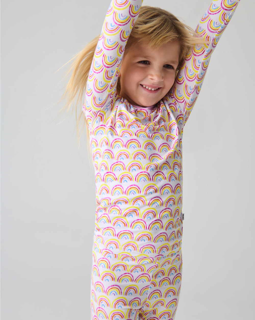 Close up of child wearing the Pastel Rainbows Two-Piece Pajama Set