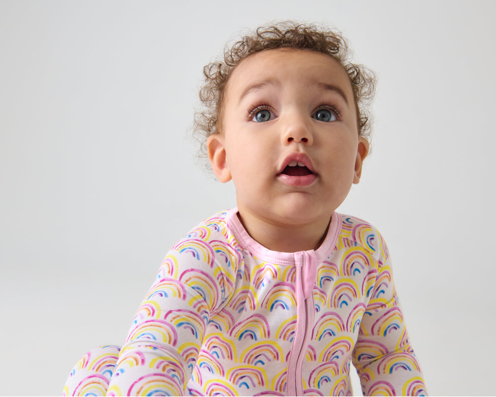 Close up of baby wearing the Pastel Rainbows Zippy