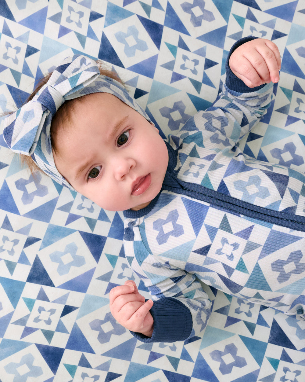 Baby laying on the Patchwork Indigo Fitted Crib Sheet